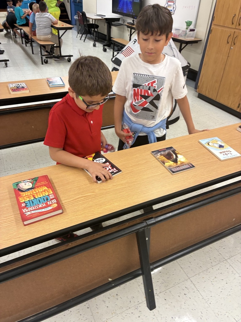 Two boys looking at book