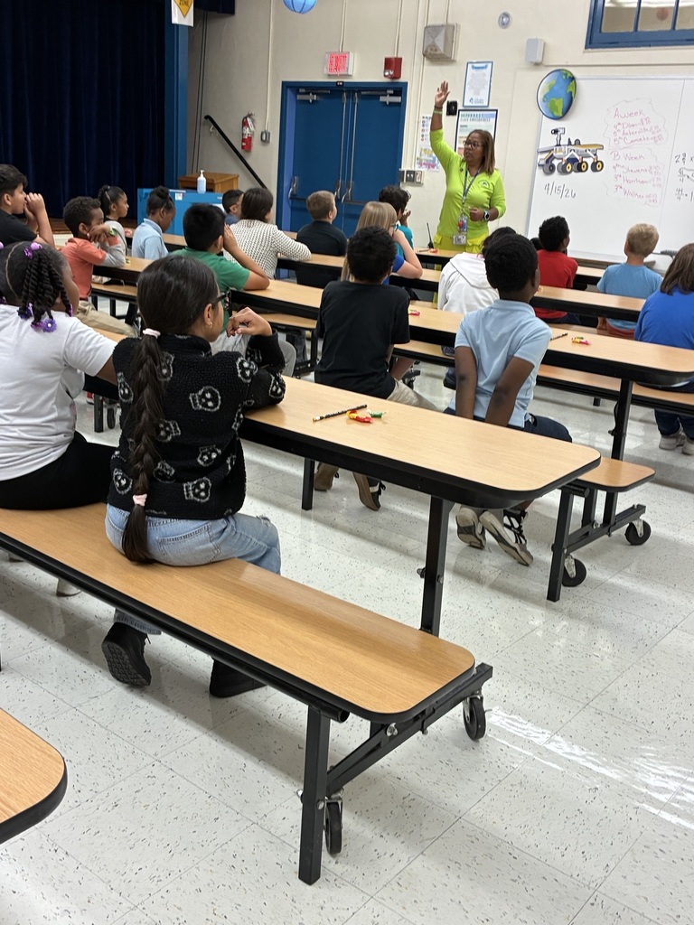  Students sit at tables