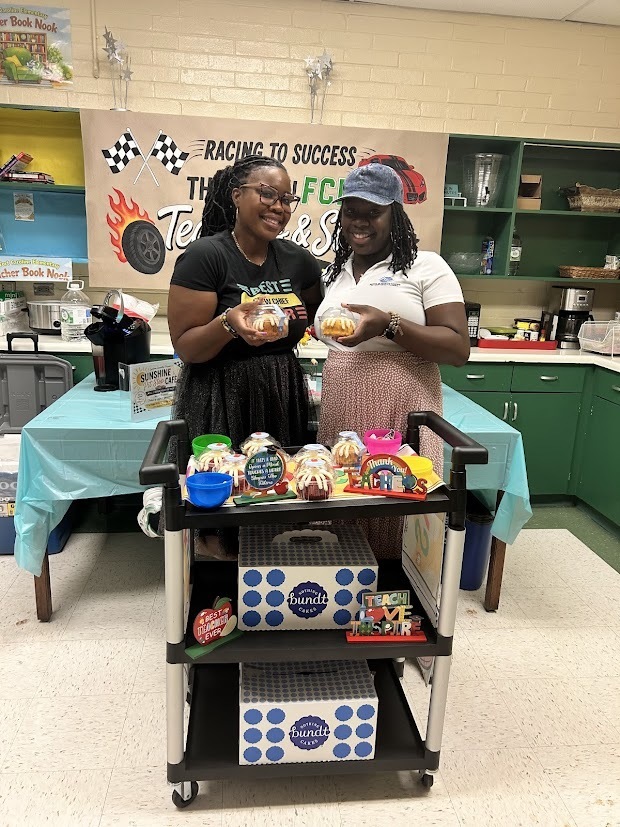 Dr. RG and Ms. Hill from BGC posing with the Nothing Bundt Cakes for Teacher Appreciation Week