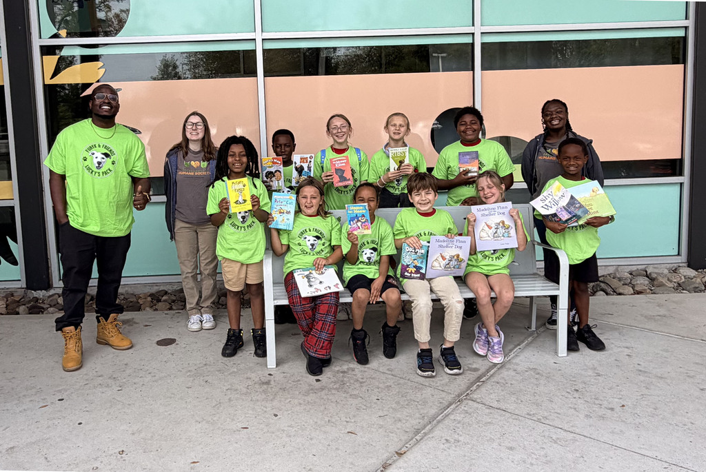 A group of student volunteers poses in front of the Jacksonville Humane Society 