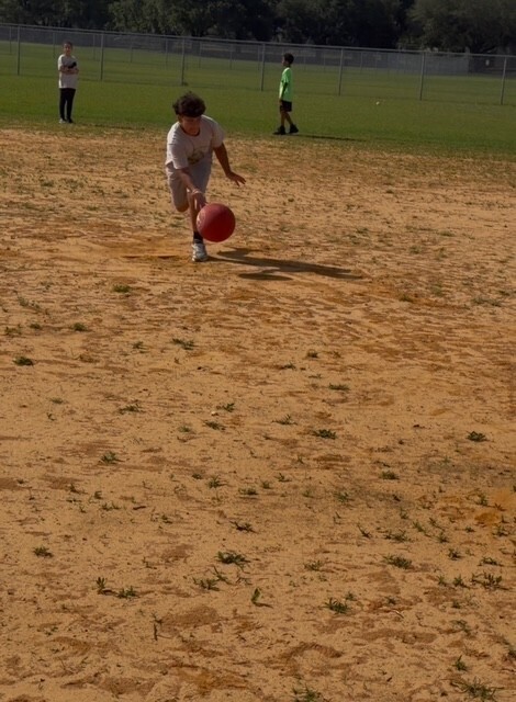 A boy student trying to catch and airball
