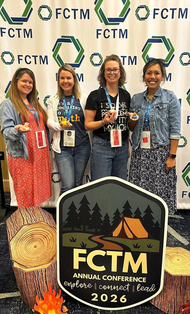 Four women wearing IDs pose behind a backdrop with a log design, a tent, and the text "FCTM Annual Conference 2026".