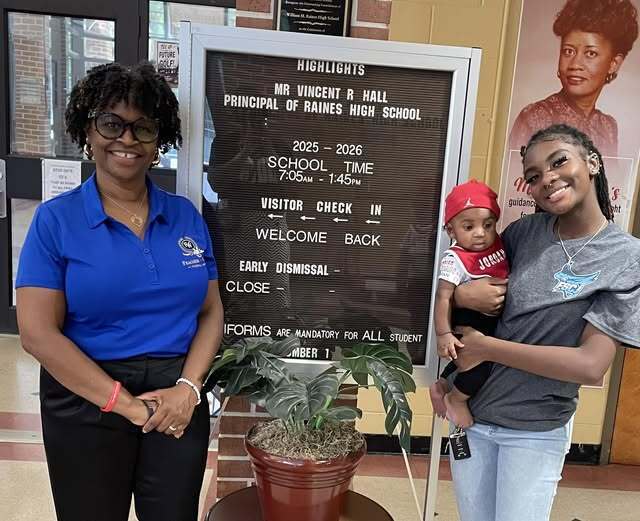 Terona Feacher awards student Kanijah with a scholarship from the Mike Freeland Foundation