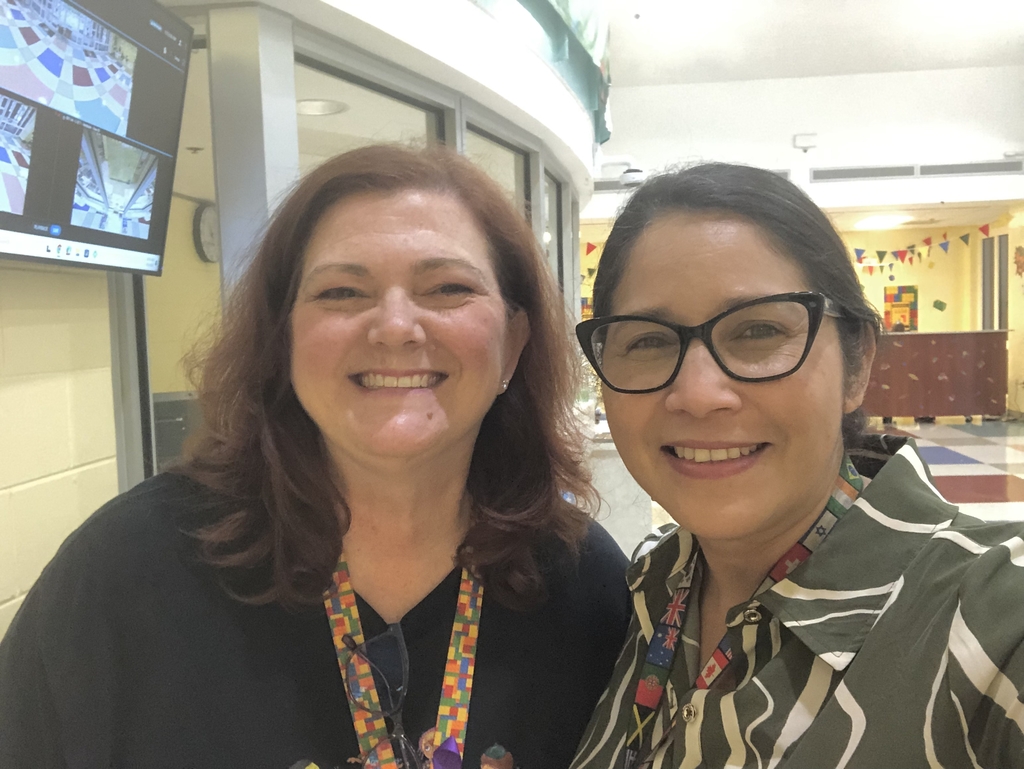 The Principal of Chet's Creek Elementary stands smiling for a photo with the DCPS ESOL coordinator.