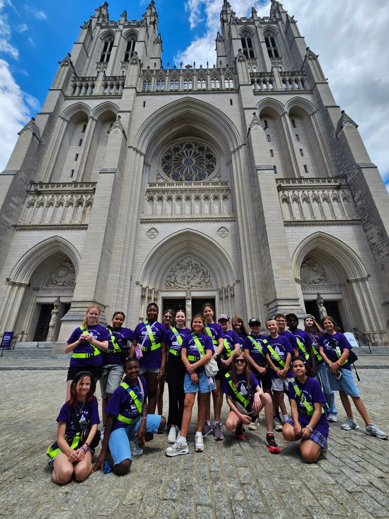 The Pine Forest Safety Patrols stand posing for a picture in front of the DC National Cathedral.