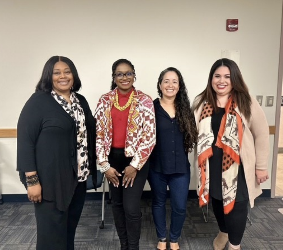 A group of four people posing for a photo as part of the Family Engagement event