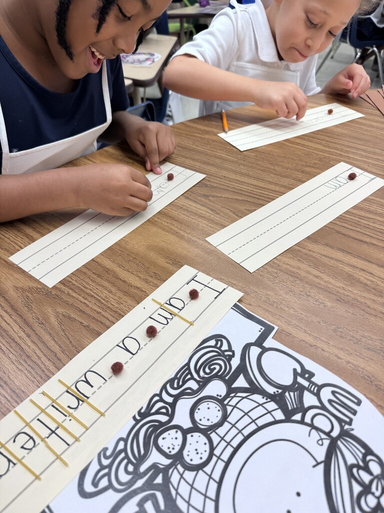 student writing a sentence using spaghetti noodle and pom pom "meatball" as spacers