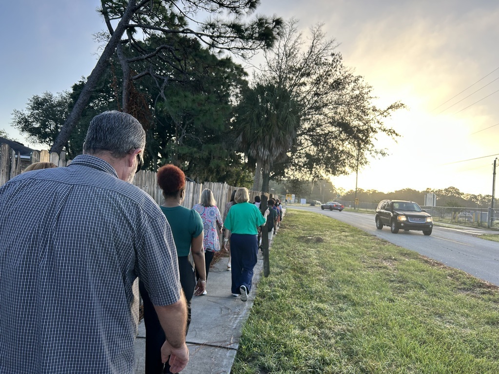 students and staff using the sidewalk to walk to school