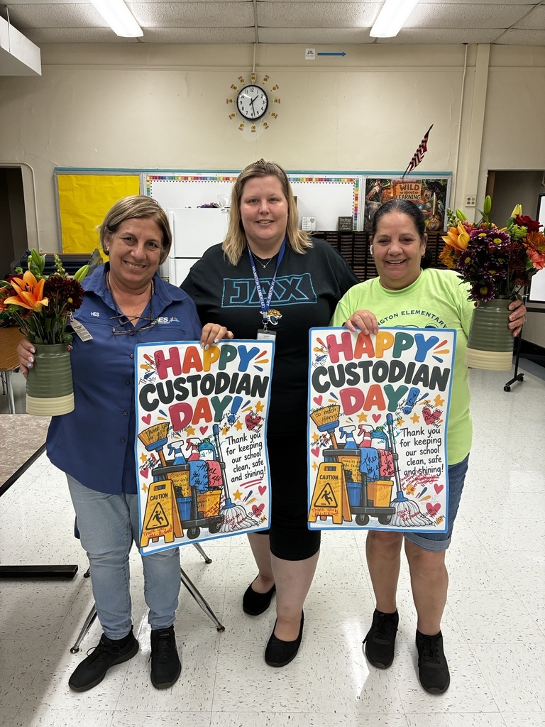 Three women hold signs that read "Happy Custodian Day." One woman has flowers in a vase.