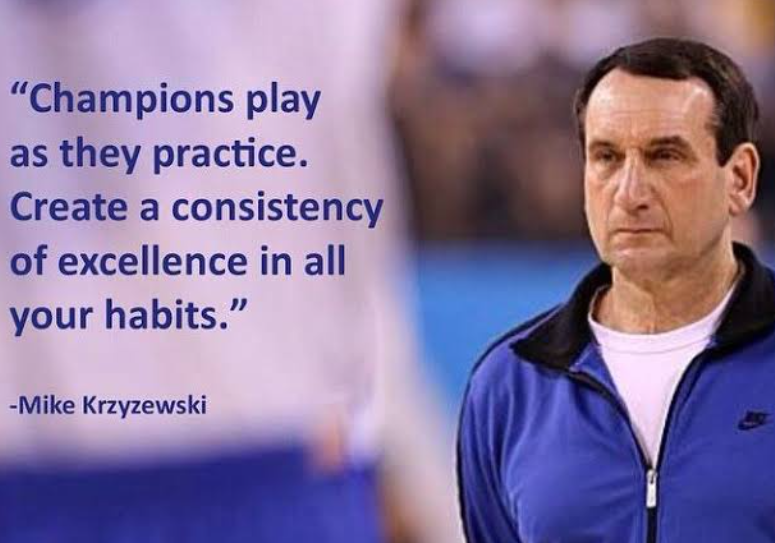 A man in a blue jacket with white shirt and black trim stands in a sports setting. Quote overlay reads, "Champions play as they practice. Create a consistency of excellence in all your habits."