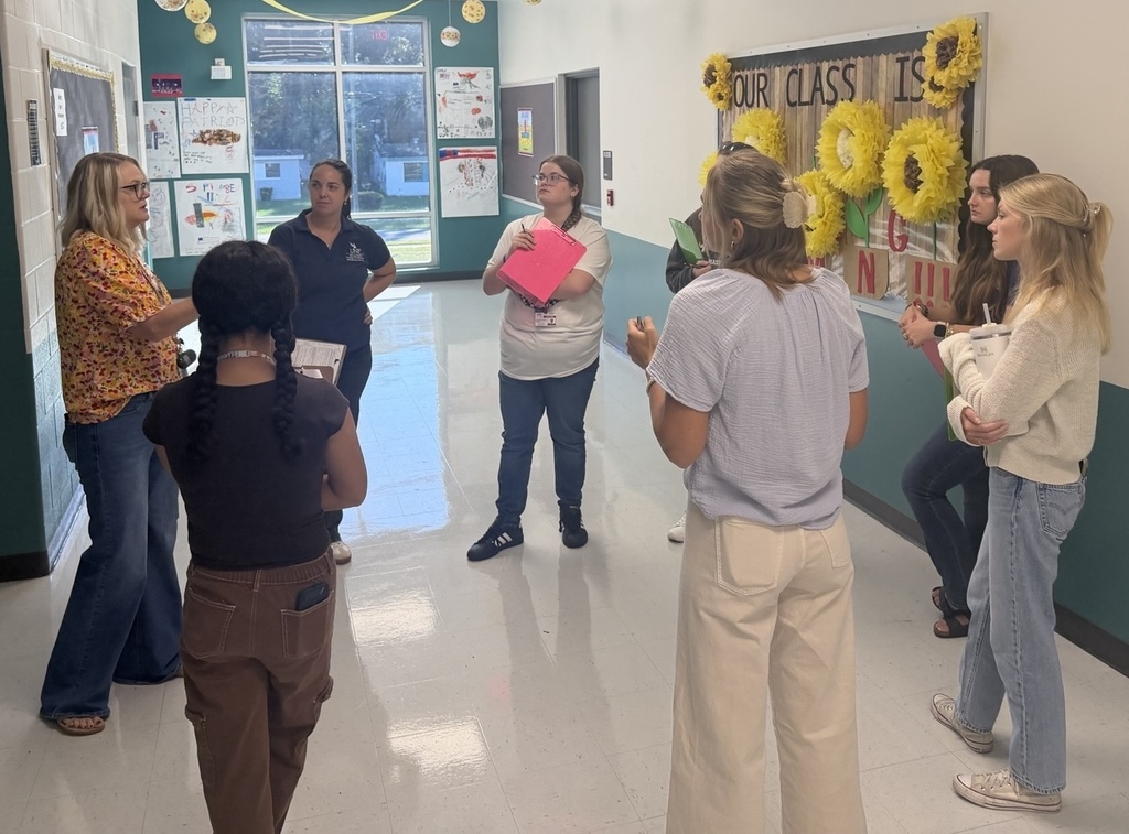 A group of residency teachers receives a lesson during the Learning Rounds program.