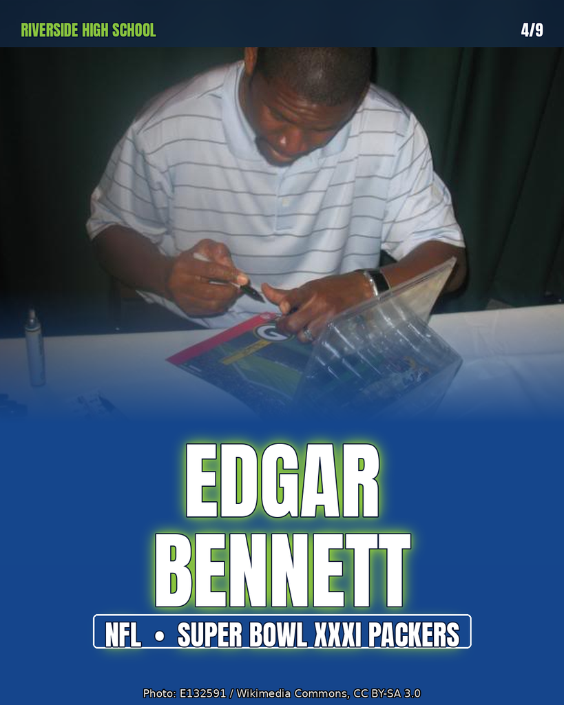 Person writing on a book at a table. A sign with the name Edgar Bennett.