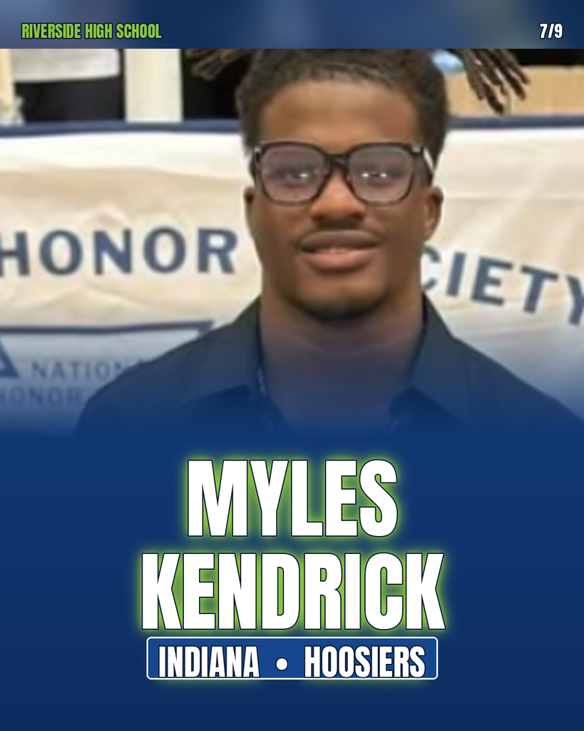 Man in glasses smiles, standing in front of banner reading "HONOR SOCIETY" and "MYLES KENDRICK, INDIANA HOOSIER".