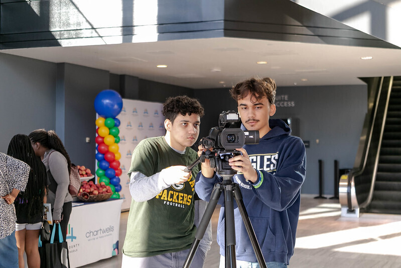 two students working with video camera