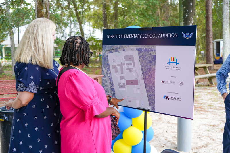 Two women looking at sign