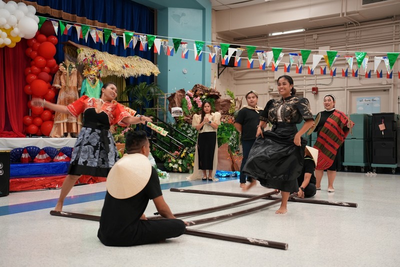Filipino teachers dancing the national dance of the Philippines