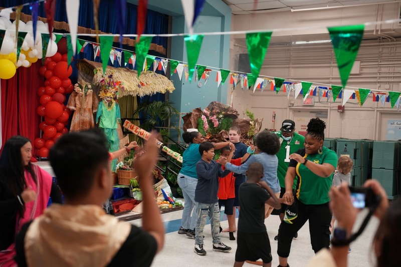 a teacher teaching jamaican dance to participants
