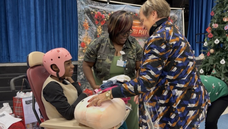 UF staff giving gifts to a student