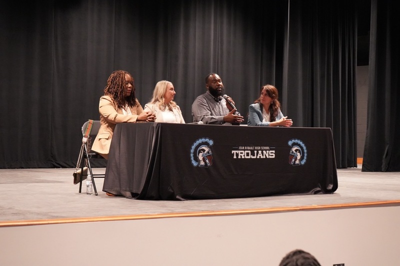 A guest speaker addresses students from on stage at the summit