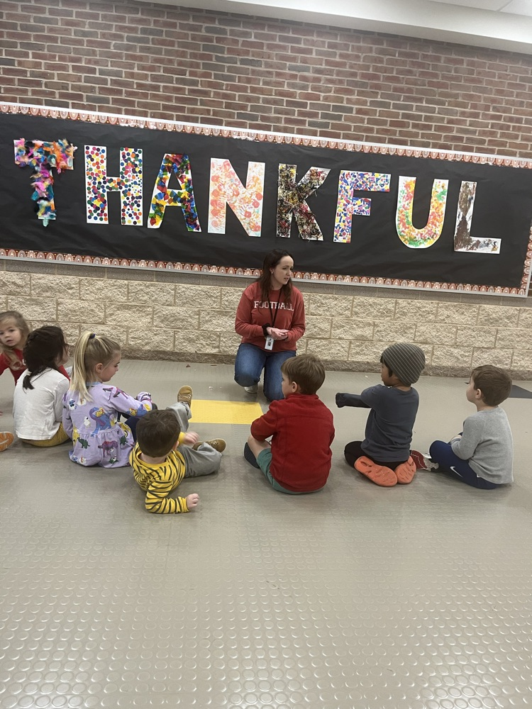 preschool students I. front of “Thankful” sign
