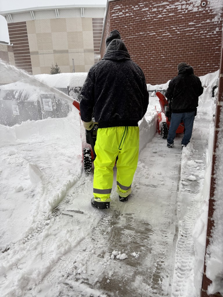 School custodians clearing snow