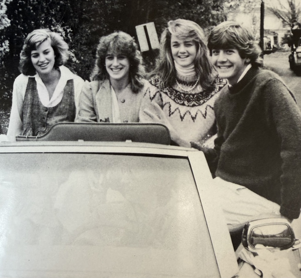 1984 Homecoming photo, four students in car