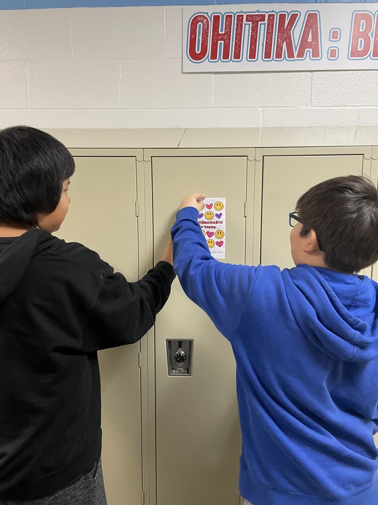 Natural Helpers putting up sign.