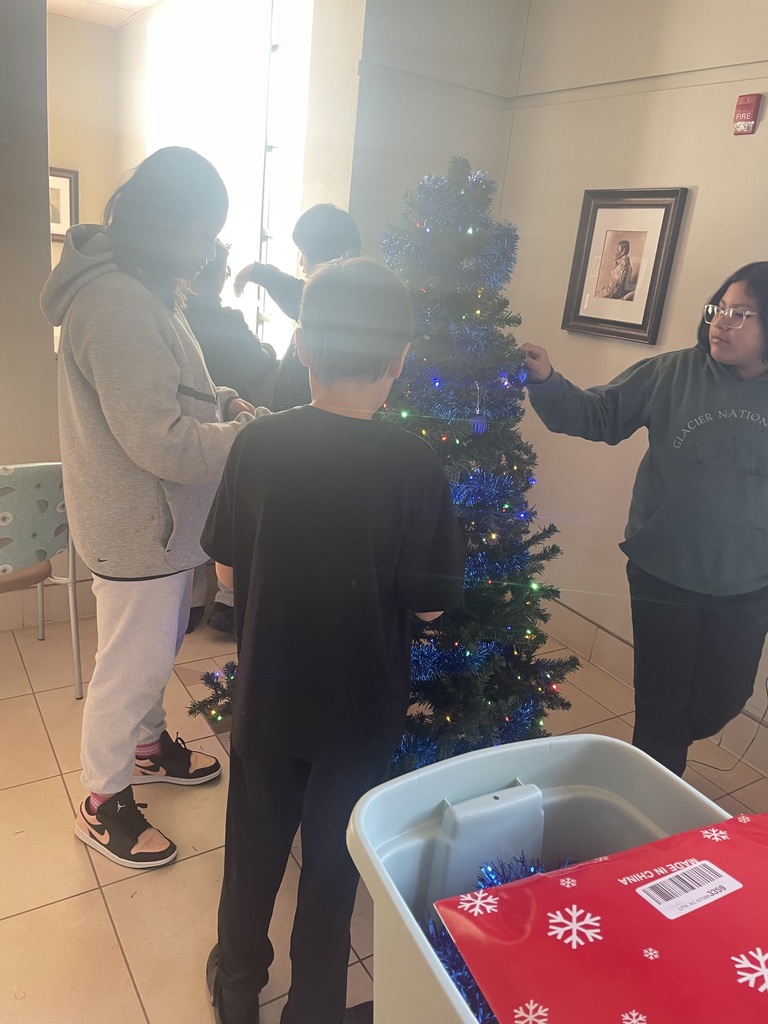 Helpers decorating tree at IHS.