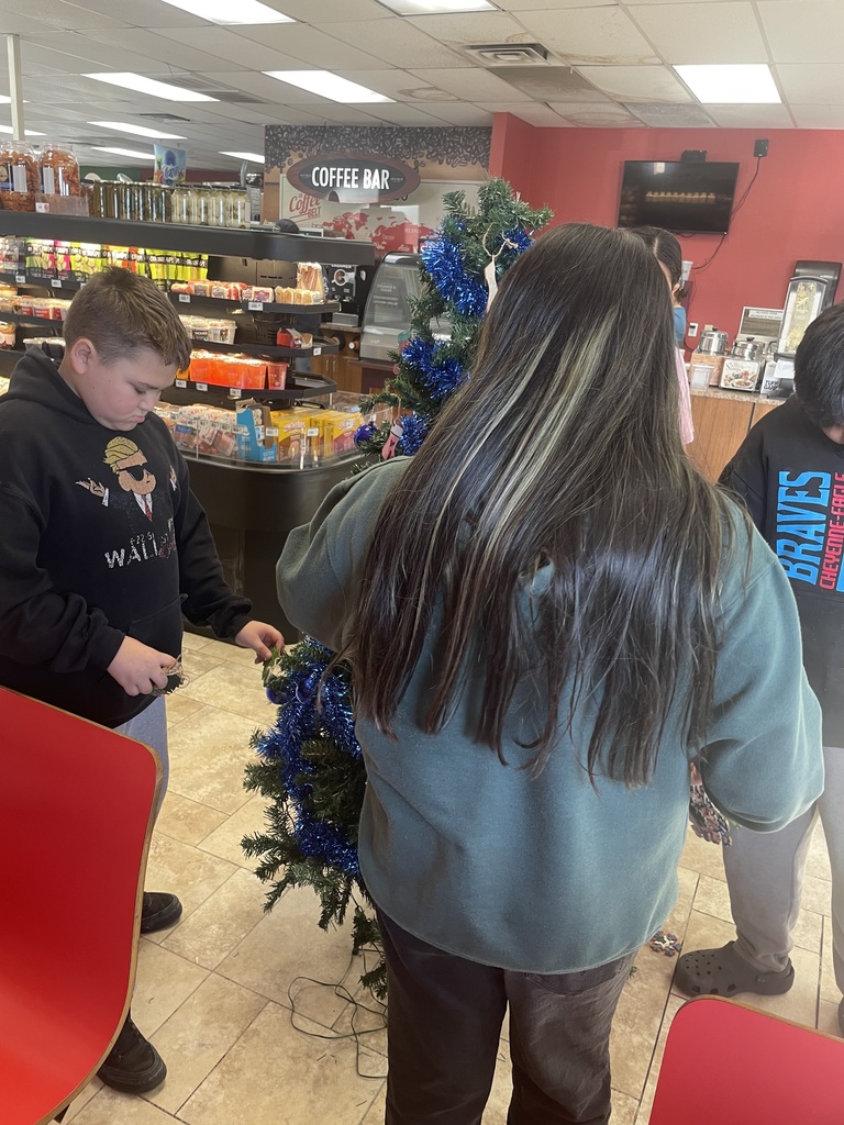 Helpers decorating tree at Eagle Butte Co-Op.