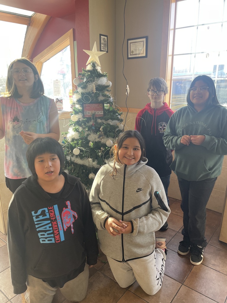 Helpers decorating a tree at Dairy Queen.