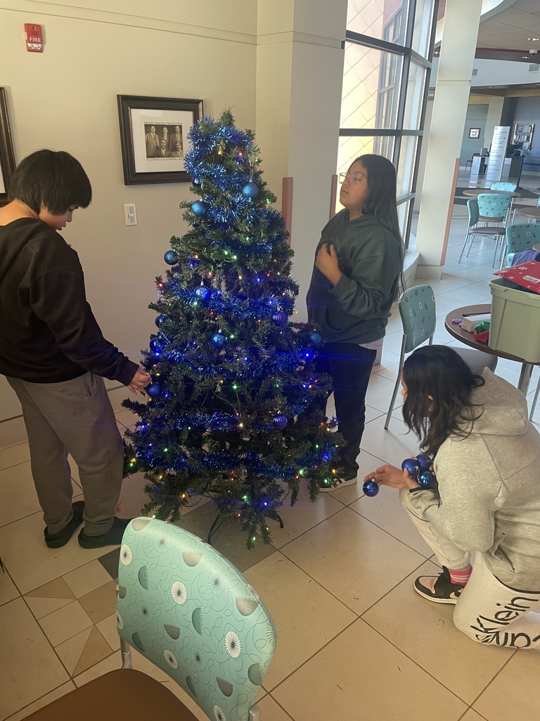 Helpers decorating tree at IHS.