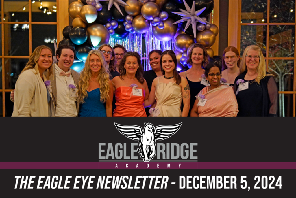 group of smiling people in formal dress in front of balloon arch with school logo and date