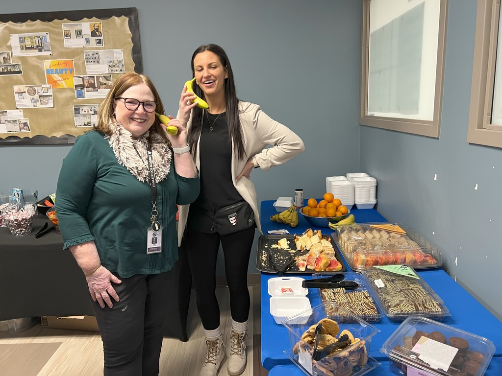 two women pretending to talk on cell phone bananas