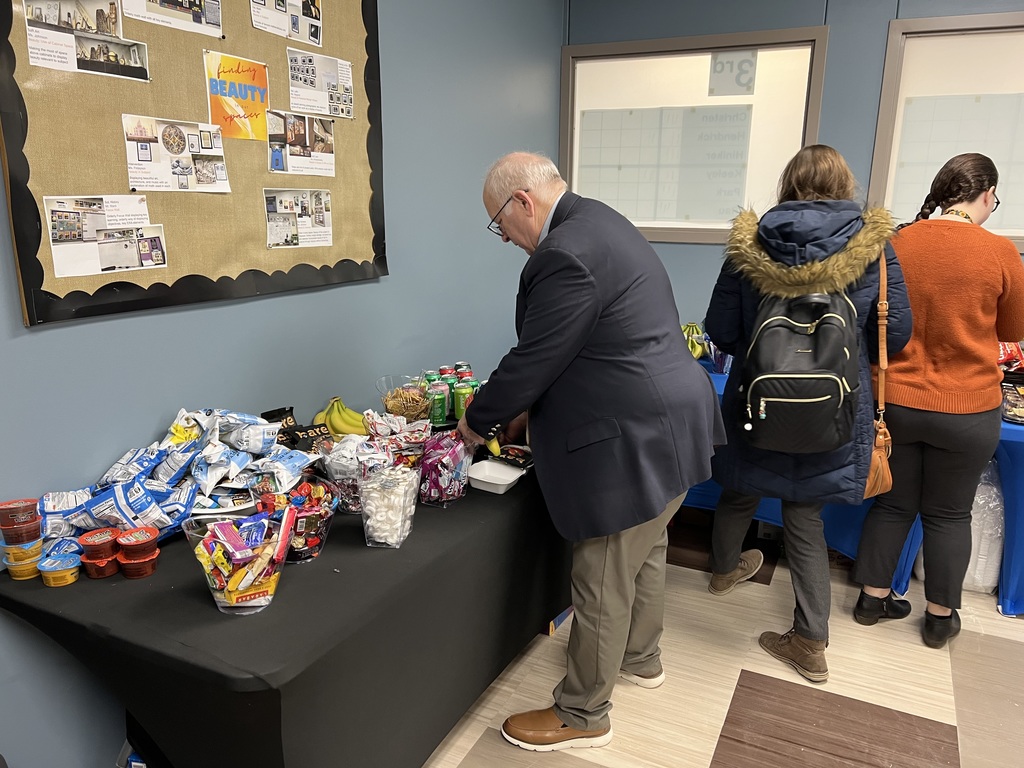 man leaning over table of food