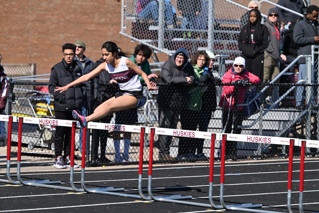 girl jumping a hurdle