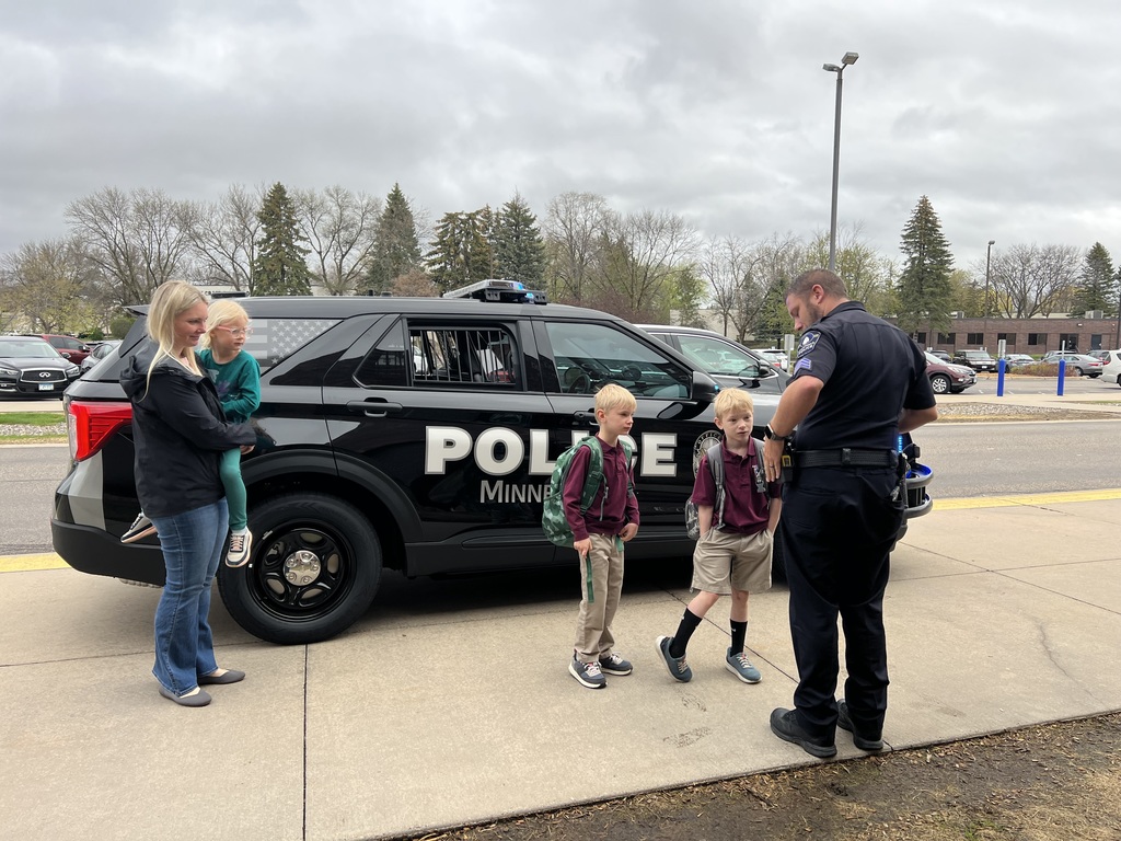 kids in front of a police car