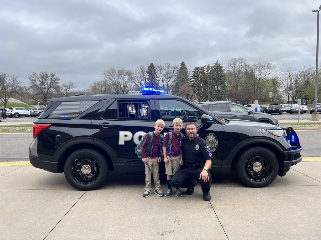 kids in front of a police car