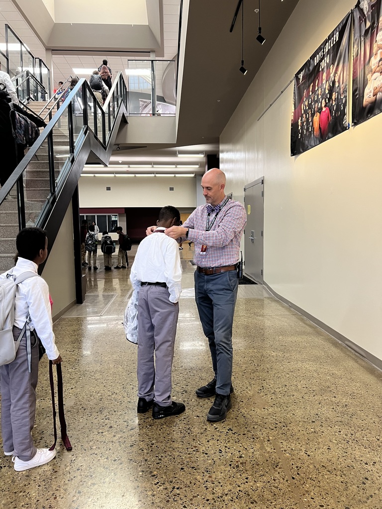 Mr. Deuth helping a student with their tie