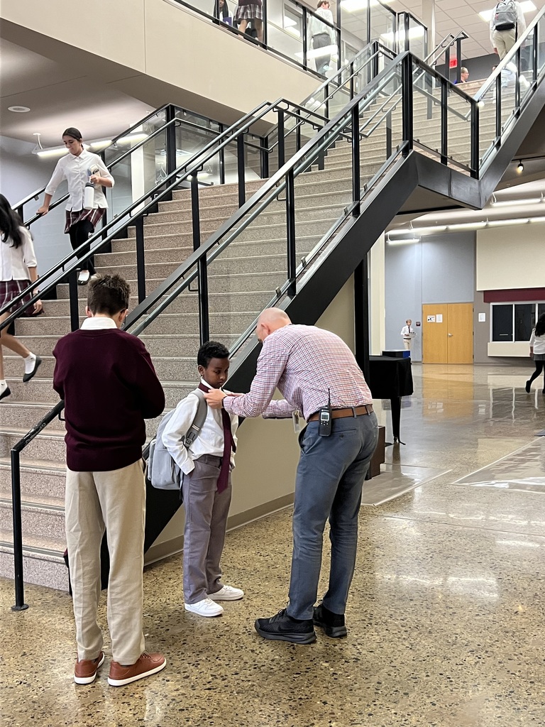 Mr. Deuth helping a student with their tie