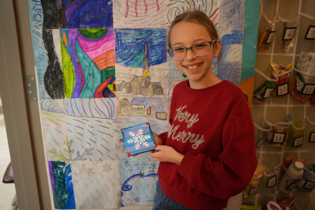 student with winter craft