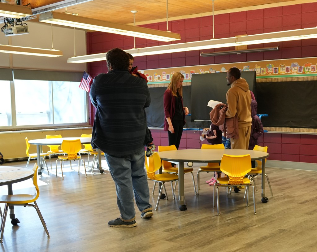 families talking with each other inside a classroom