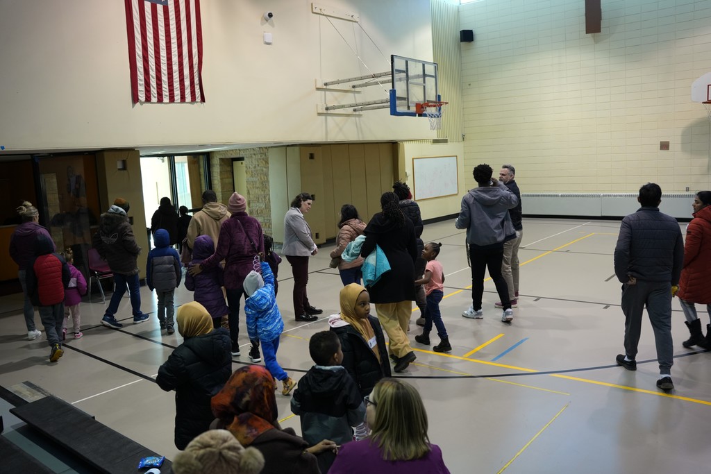 families leaving the gym after a presentation 