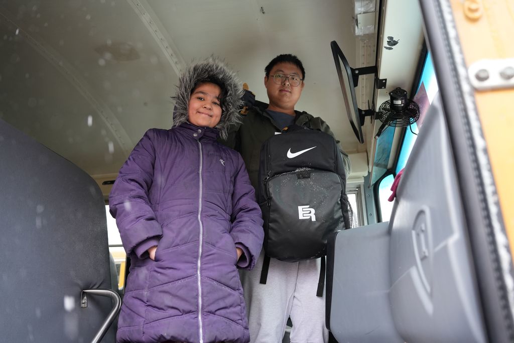 student with bus driver