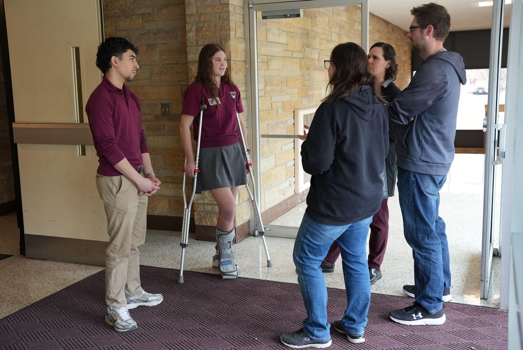 student ambassadors with a family