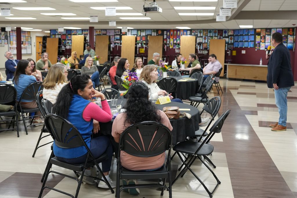 group laughing at tables