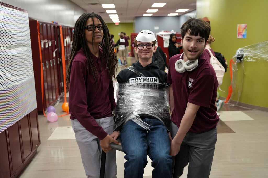 student wrapped up in cellophane