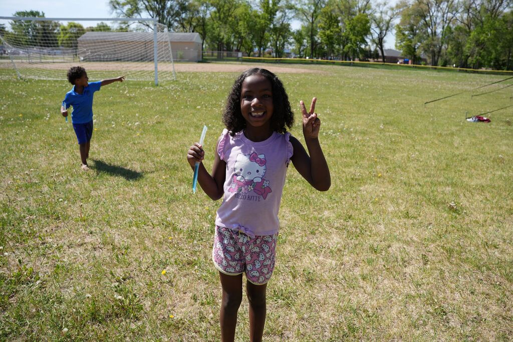 kid smiling with peace sign