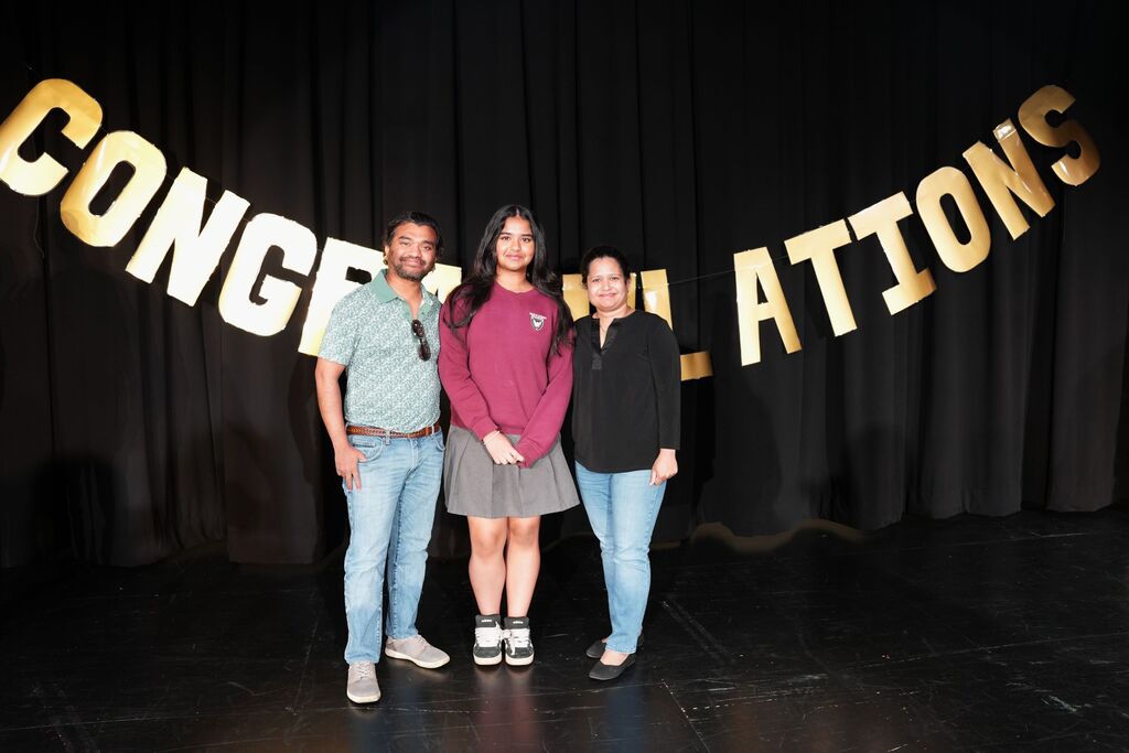 family with congratulations sign