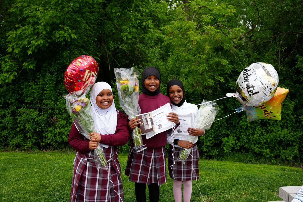 fourth graders with flowers and balloons