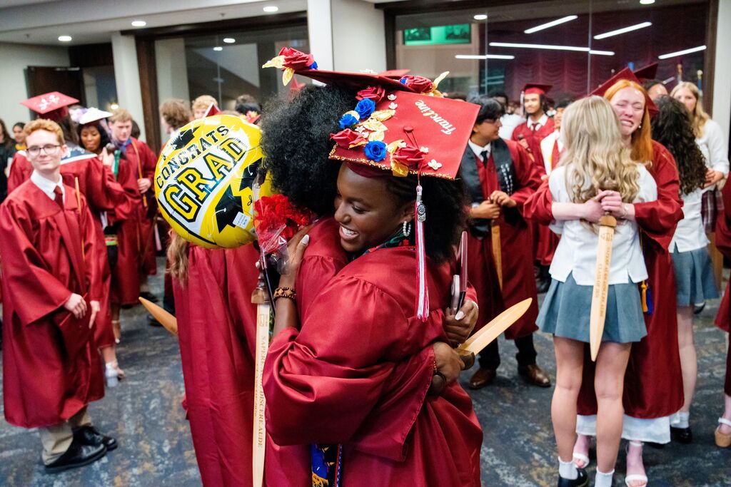 graduates hugging